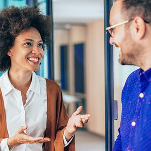 People talking and smiling in a corridor